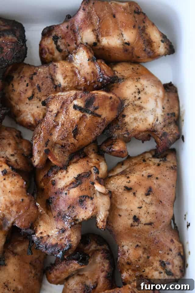 Grilled Chicken with Our Signature Teriyaki Glaze 6 Grilled teriyaki chicken thighs in white dish.