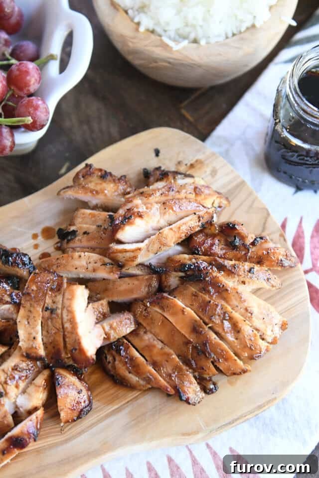Grilled Chicken with Our Signature Teriyaki Glaze 7 Slices of grilled teriyaki chicken on wood cutting board.