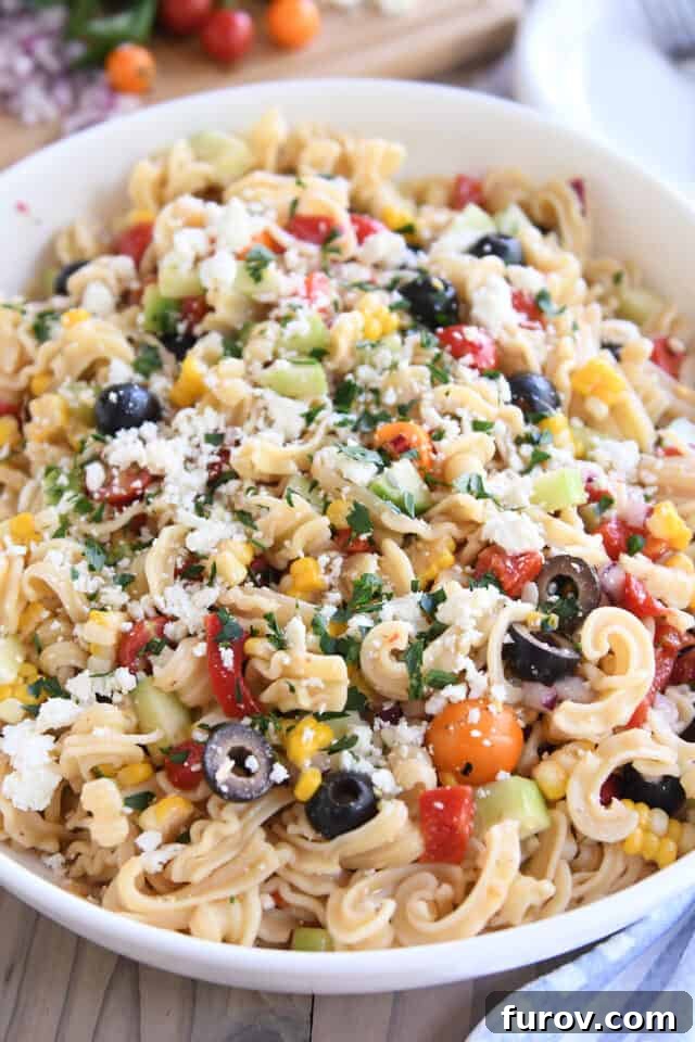 Zesty Mediterranean Pasta Salad 2 Easy Greek pasta salad in white serving bowl.