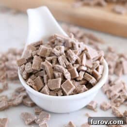 White bowl with chopped cinnamon bits for baking.