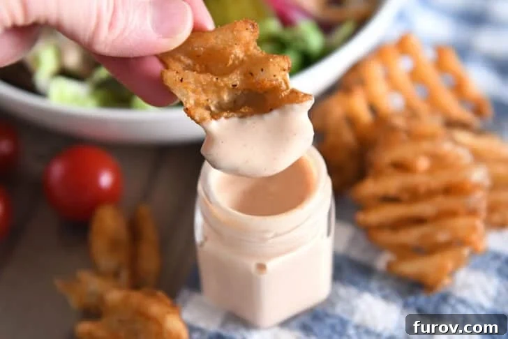 Dipping sweet potato waffle fry in creamy sauce.