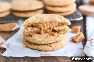two brown butter caramel snickerdoodles stacked with one cookie broken in half on top