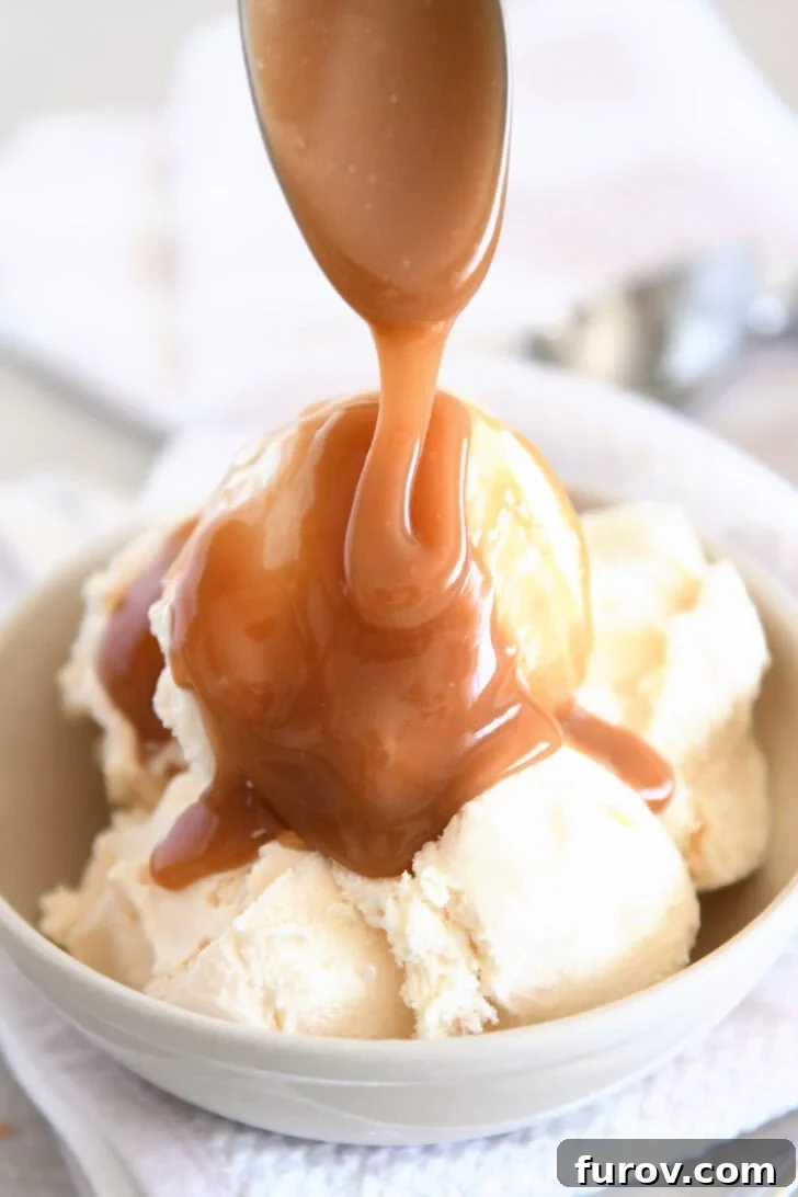Drizzling caramel sauce over vanilla ice cream.