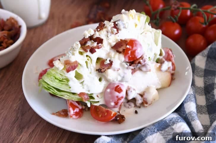 Loaded Wedge Salad with Bacon, Blue Cheese and Ranch Dressing 3 White plate with one iceberg wedge, blue cheese crumbles, blue cheese dressing, tomatoes, bacon, and sliced apples.