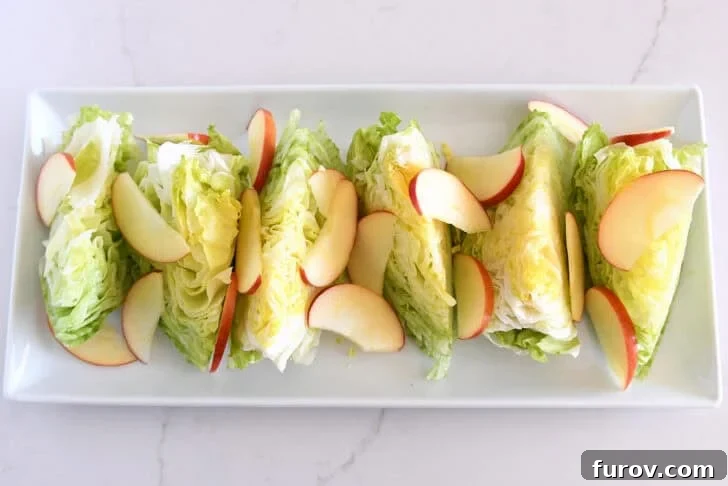 Loaded Wedge Salad with Bacon, Blue Cheese and Ranch Dressing 7 White platter with iceberg wedges and sliced apples.