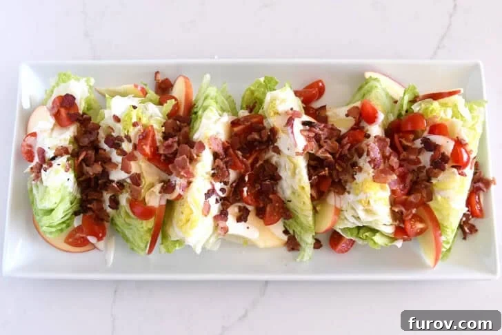 Loaded Wedge Salad with Bacon, Blue Cheese and Ranch Dressing 10 White platter with iceberg wedges, tomatoes, sliced apples, bacon, and blue cheese dressing.