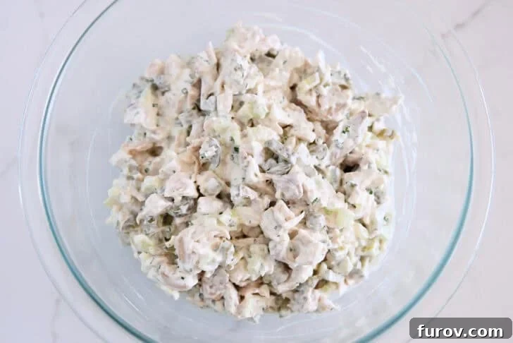 Glass bowl with creamy dill pickle chicken salad.