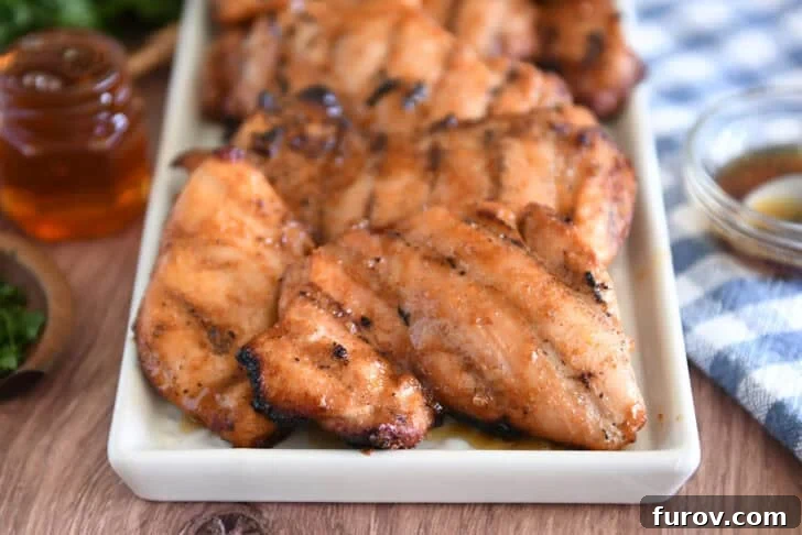 White tray with five or six pieces of grilled honey garlic chicken.