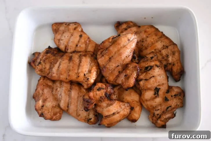 White pan with five or six pieces of grilled honey garlic chicken.
