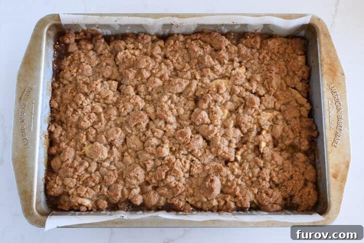 Baked metal 9X13-inch pan of caramel apple pie bars.