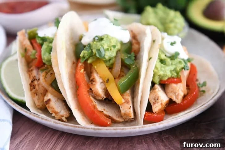 Sizzling Chicken Fajitas with Peppers and Onions 6 Three flour tortillas filled with sliced, cooked chicken, bell peppers, onions, guacamole and sour cream.